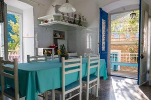 a dining room with a blue table and chairs at Vintage Apartment Nona in Mošćenička Draga