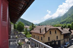 a balcony of a building with mountains in the background at Hôtel et appart'hôtel de l'Hermitage in Thônes