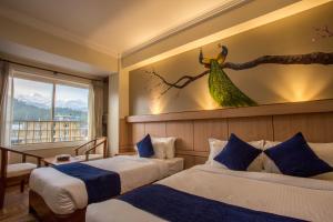 Postel nebo postele na pokoji v ubytování Hotel White Pearl