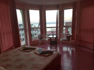 a bedroom with a bed and a view of the ocean at Hotel Saint Tatyana in Sveti Vlas