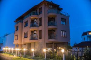 a tall building with lights in front of it at Guest House Georgievi in Primorsko