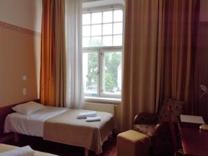 a hotel room with a bed and a window at Kesähotelli Aurora in Tampere
