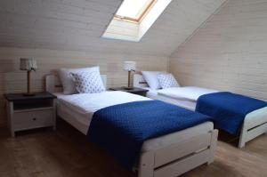 a attic bedroom with two beds and a skylight at A Morze Ustka in Ustka