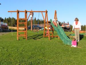 a woman and a child playing on a playground at Moravská Bouda in Špindlerův Mlýn