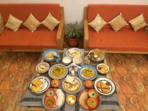 a tray of food on a table with plates of food at Villa Baywalk Goa - 200 meters from Morjim Beach in Morjim
