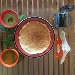 a table with two bowls of soup and a pie at Villa Baywalk Goa - 200 meters from Morjim Beach in Morjim