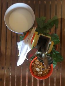 a bowl of food with a strainer and a plate of food at Villa Baywalk Goa - 200 meters from Morjim Beach in Morjim