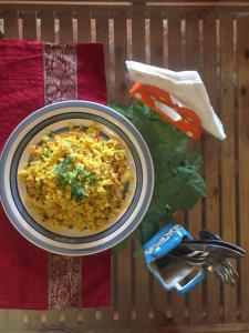 a plate of food on a table with a bowl of rice at Villa Baywalk Goa - 200 meters from Morjim Beach in Morjim