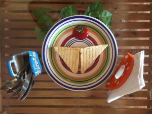 a plate of food with a tortilla and a cherry on top at Villa Baywalk Goa - 200 meters from Morjim Beach in Morjim
