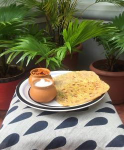 a plate of food with a tortilla on a table at Villa Baywalk Goa - 200 meters from Morjim Beach in Morjim