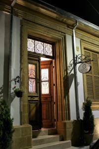 a building with a wooden door and windows at Pedieos Guest House in Lefkosa Turk