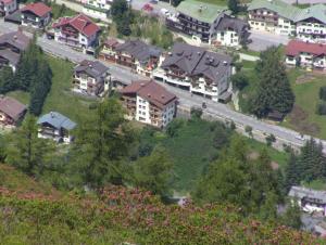 a group of houses on a hill next to a road at Alkira in Sankt Anton am Arlberg