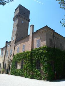 an ivycovered building with a tower on top of it at Lally House in Pesaro