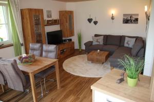 a living room with a couch and a table at Am Schwand in Grän