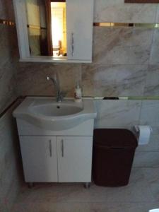 a bathroom with a sink and a mirror at New toprak suite in Uzungöl +32 photos