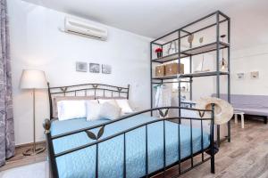 a bedroom with a bed with blue sheets and a shelf at Anchor Apartments in Stari Grad +89 photos