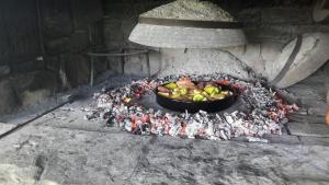 a pot of fruit is sitting in an oven at Mandić Rooms in Goriš