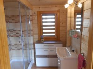 a bathroom with a shower and a sink at Domek pod Świerkiem in Wapnica +26 photos