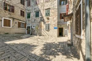 an alley in an old town with buildings at Hostel Pula in Pula