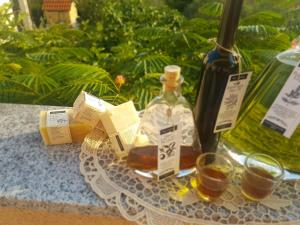 a bottle of whiskey and two glasses on a table at Apartments Villa Marija in Gornji Karin