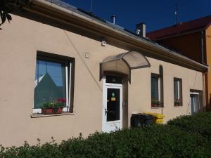 a house with a white door and a window at Apartmán Olomouc 2+KK in Olomouc
