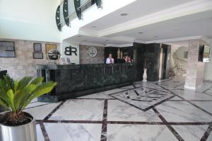 a lobby with a bar with a person in the background at Bugday Hotel in Ankara
