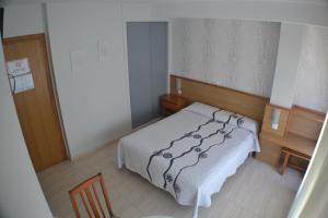 Łóżko lub łóżka w pokoju w obiekcie Hostal Casa Maria