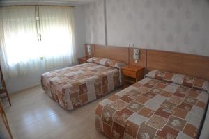 Łóżko lub łóżka w pokoju w obiekcie Hostal Casa Maria