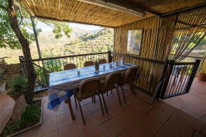 a table and chairs on a balcony with a view at Hatzikyprianou Museum Studio in Lazania