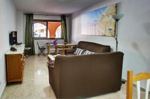 a living room with a couch and a desk at Marody Tenerife House in El Médano