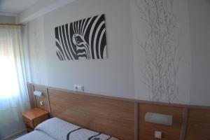Łóżko lub łóżka w pokoju w obiekcie Hostal Casa Maria