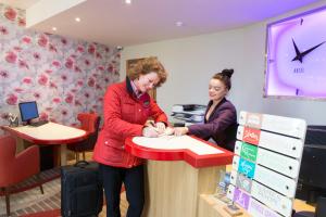 two women standing at a counter in a store at Prom Hotel in Great Yarmouth