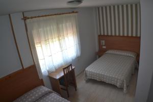 Łóżko lub łóżka w pokoju w obiekcie Hostal Casa Maria