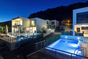 a villa with a swimming pool at night at Villa Selina - Nera in Makarska