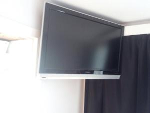 a flat screen tv hanging on a wall at The coolest baby penthouse in Oostende in Ostend