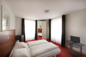 Postel nebo postele na pokoji v ubytování Spalenbrunnen Hotel & Restaurant Basel City Center