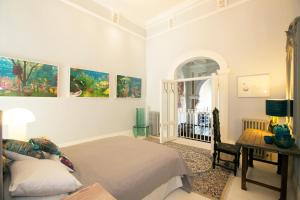 a bedroom with a bed and a desk and paintings at The Chapel Boutique Bed and Breakfast in Harrogate