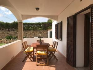 a patio with a table and chairs on a balcony at Azienda Multifunzionale S'Ozastro in Santa Marinella