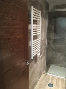 a wooden door with a window in a bathroom at La Pinilla Ski Apartment in Riaza