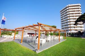 a group of tables and chairs under a pavilion at Torre Del Sole in Terracina