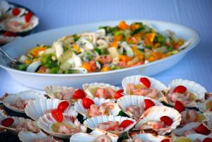 a table topped with bowls of food with shrimp at Torre Del Sole in Terracina