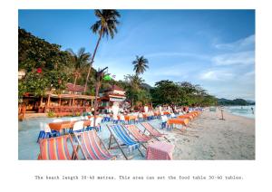 un montón de sillas y sillas en una playa en Mac Resort Hotel en Ko Chang