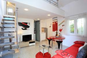 a living room with a couch and a table at Apartments Ella in Split