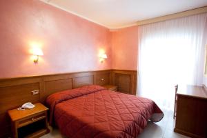 Postel nebo postele na pokoji v ubytování Hotel Sporting