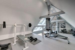 a gym with a treadmill and a treadmill in a house at Gîtes Casalé Di Vito in Longvilliers