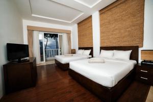 a hotel room with two beds and a television at Surf4You Residence in Mui Ne