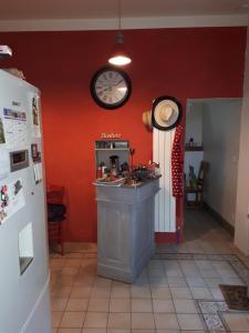 a kitchen with a counter and a clock on the wall at Villa SAINT-PRIVAT in Pouzilhac