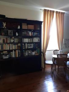 a living room with a book shelf filled with books at Villa SAINT-PRIVAT in Pouzilhac
