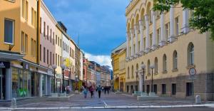 a group of people walking down a street with buildings at Apartment Mirjana in Banja Luka
