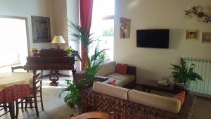 a living room with a couch and a piano at Agriturismo Gradec in Aurisina